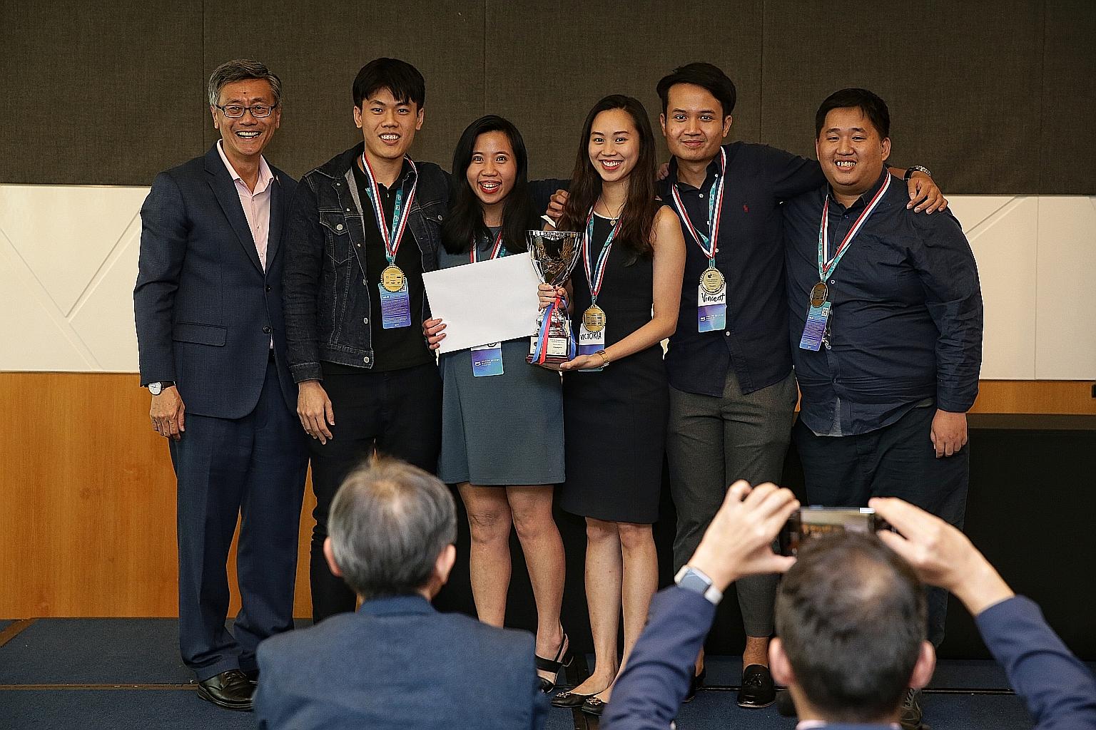 NUS president Tan Eng Chye (far left) with members of NUS' 5 Peas in a Pod - (from left) Mr Xavier Xie, 24, Ms Rebecca Tan, 25, Ms Victoria Teo, 22, Mr Vincent Leow, 24, and Mr Teo Kai Cheng, 26. The team, from the NUS School of Computing, was one of