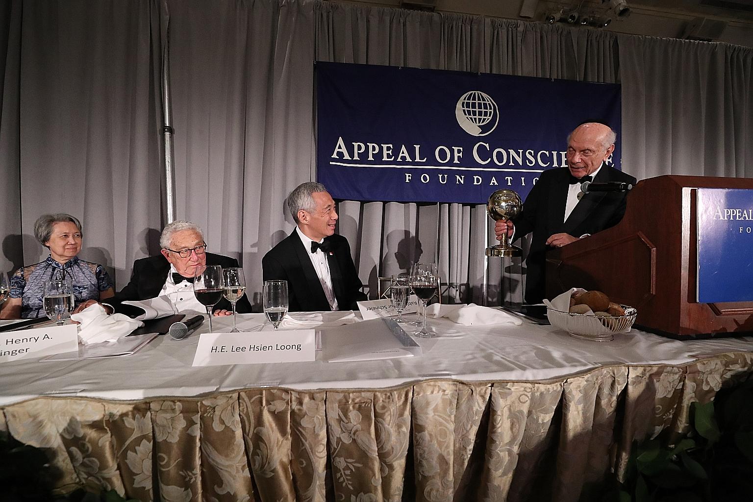 Prime Minister Lee Hsien Loong received the World Statesman Award from Rabbi Arthur Schneier, president and founder of the Appeal of Conscience Foundation, in New York on Monday. With him were Mrs Lee (from left) and former United States secretary of