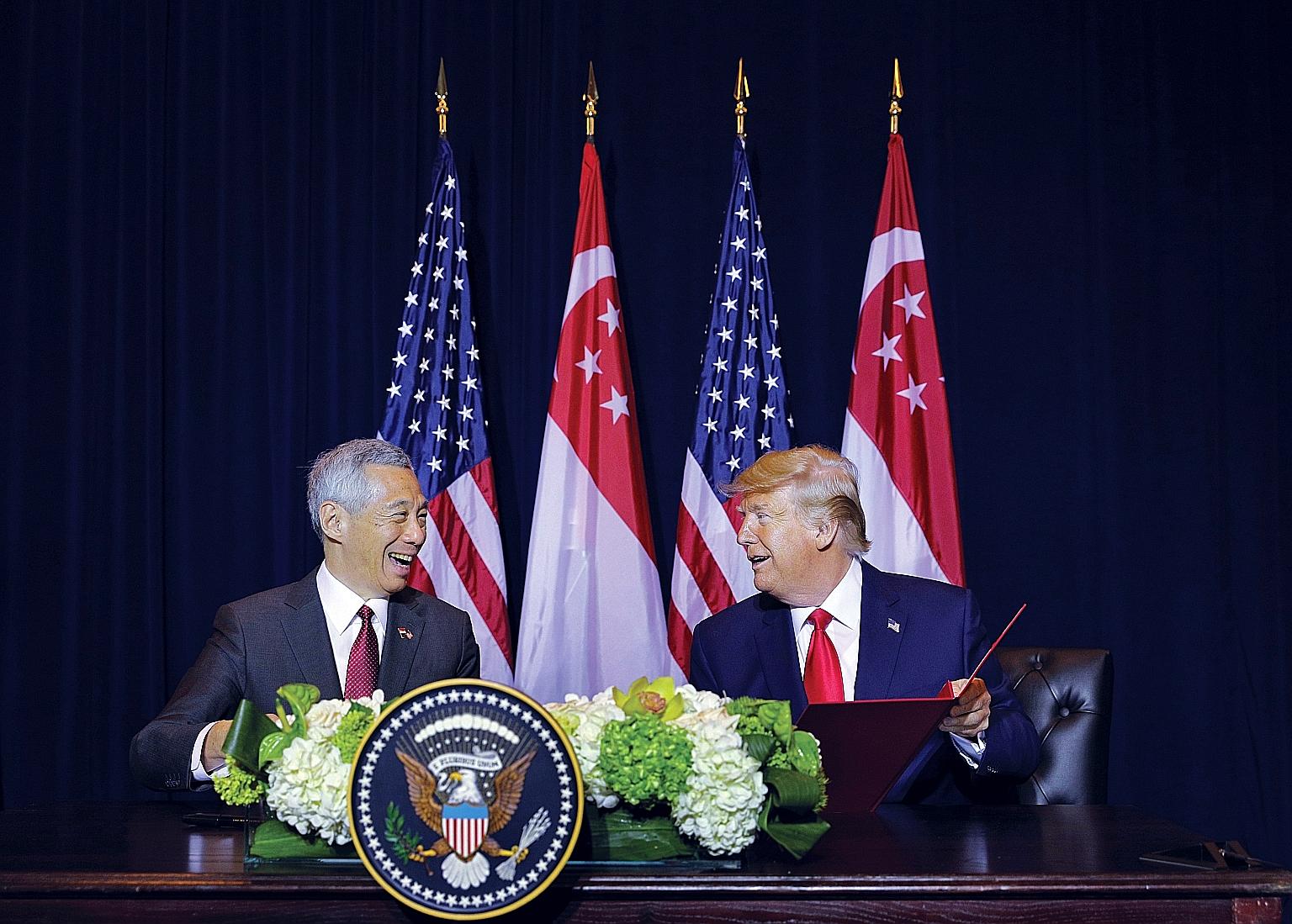 Prime Minister Lee Hsien Loong and US President Donald Trump signing an amendment to the 1990 defence agreement in New York on Monday. Both leaders lauded the close relationship between Singapore and the US. ST PHOTO: GAVIN FOO