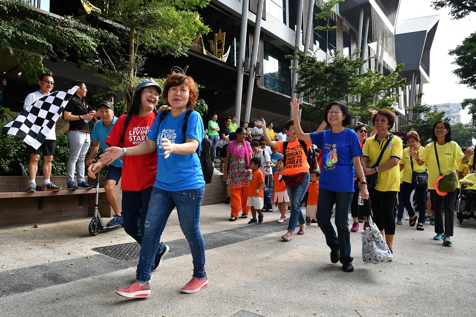 FairPrice chief executive Seah Kian Peng (left) and South East District Mayor Maliki Osman flagging off an activity in Wisma Geylang Serai for the FairPrice Walk for Rice+ @ South East campaign yesterday. Organisers aim to raise 500,000 bowls of whit