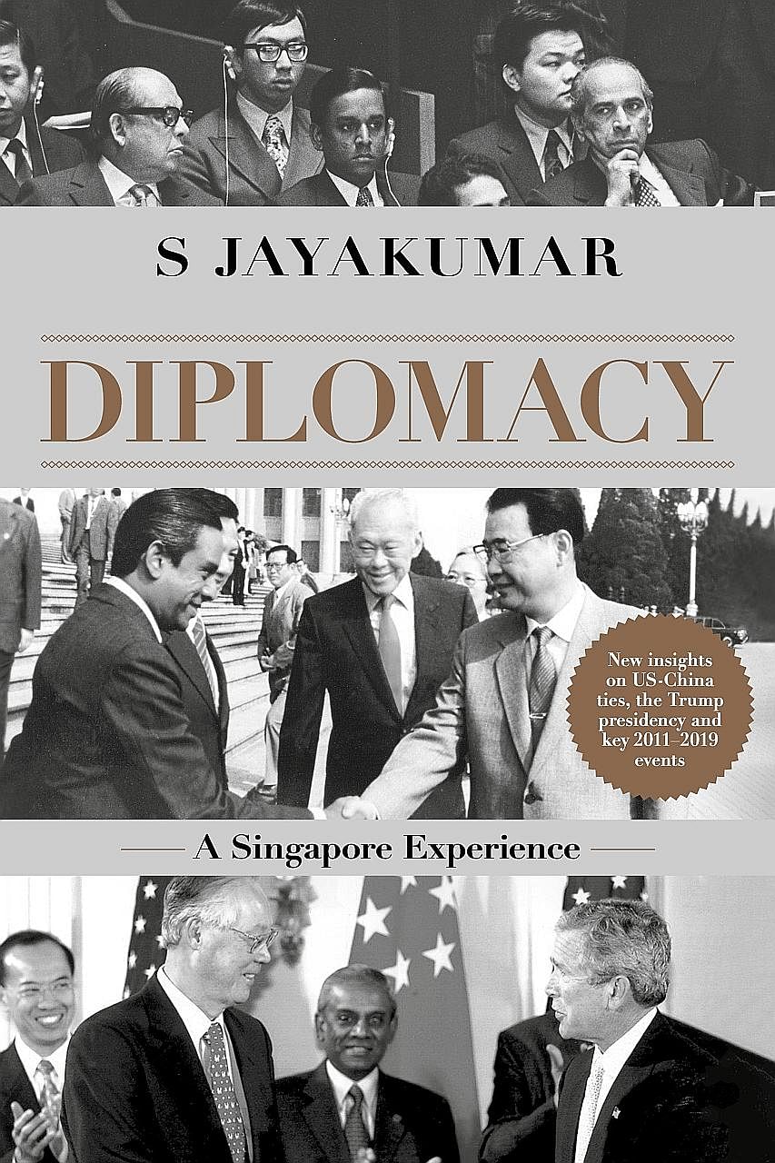 Former senior minister S. Jayakumar signing copies of his book, Diplomacy: A Singapore Experience, during The Straits Times Book Club event at the National Library on Wednesday. The book (below), which gives insights into Prof Jayakumar's years in fo