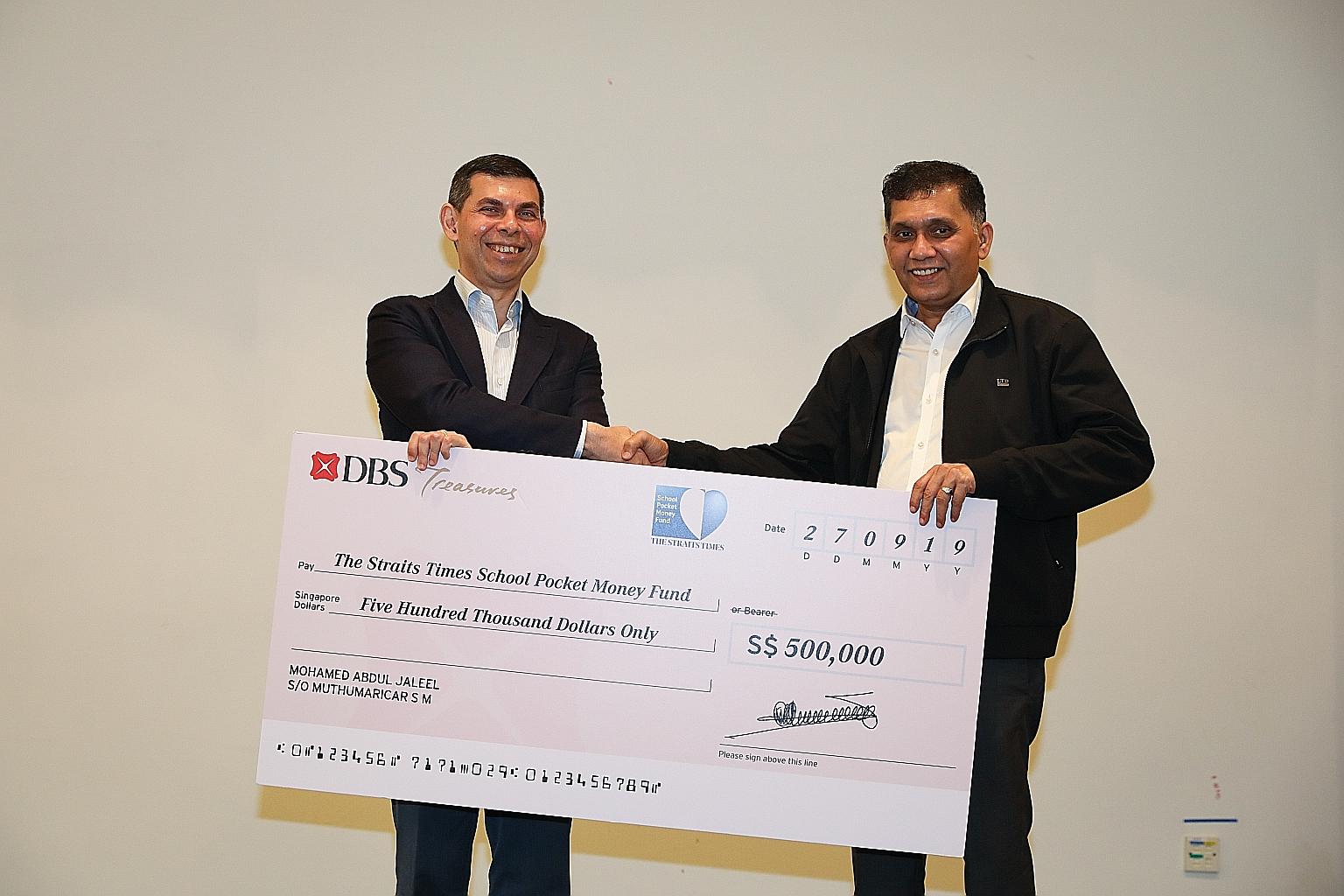 ST School Pocket Money Fund chairman Warren Fernandez (left) receiving a donation of $500,000 to the fund from Mini Environment Service Group founder and chief executive Mohamed Abdul Jaleel yesterday. Mr Jaleel, a long-time supporter of the fund, ha