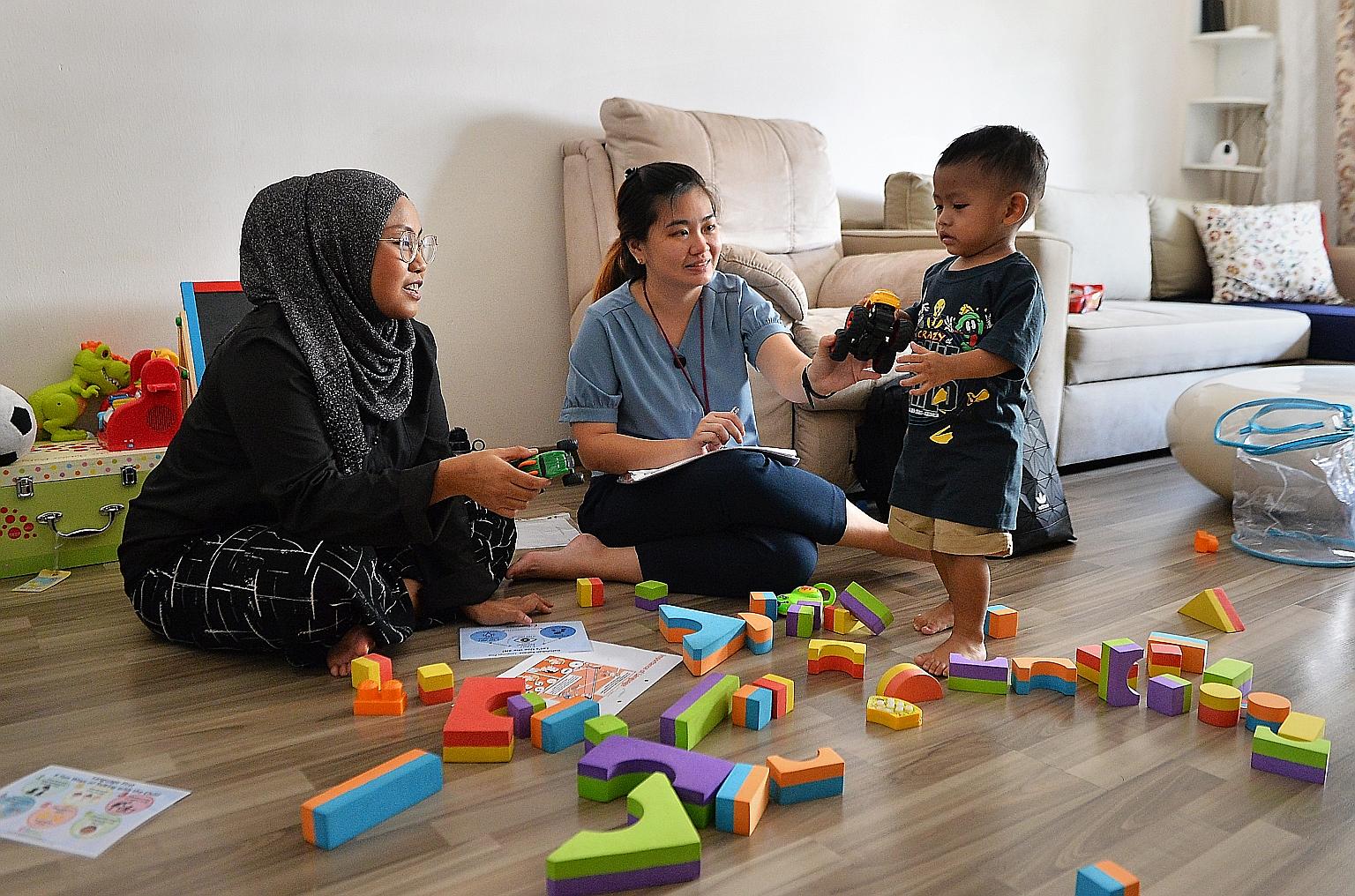 KidStart home visitor Lee Wei Qi, 32, interacting with 19-month-old Ae'dan Raphael. She has helped his mother, Ms Calista Azman, 34, by sharing parenting tips and strategies for her son's development. One feature of KidStart is that support and advic