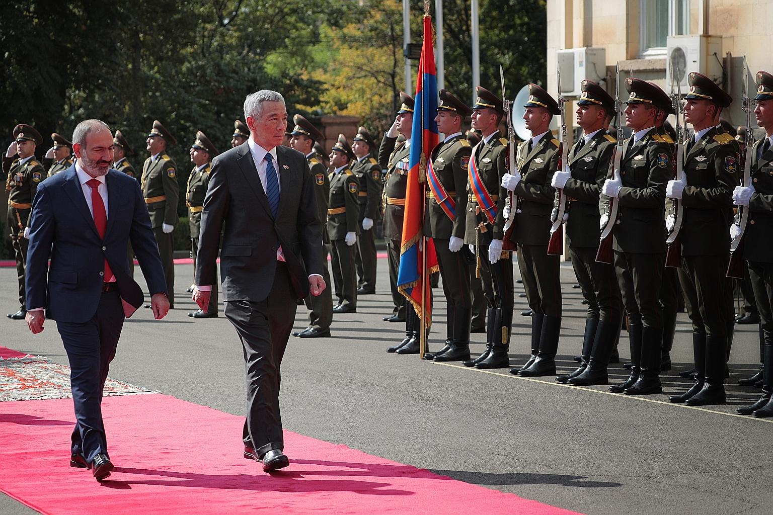 Prime Minister Lee Hsien Loong and his Armenian counterpart Nikol Pashinyan reviewing the guard of honour during a welcome ceremony at the Governmental Residence in the Armenian capital Yerevan yesterday. PM Lee said both Singapore and Armenia are sm