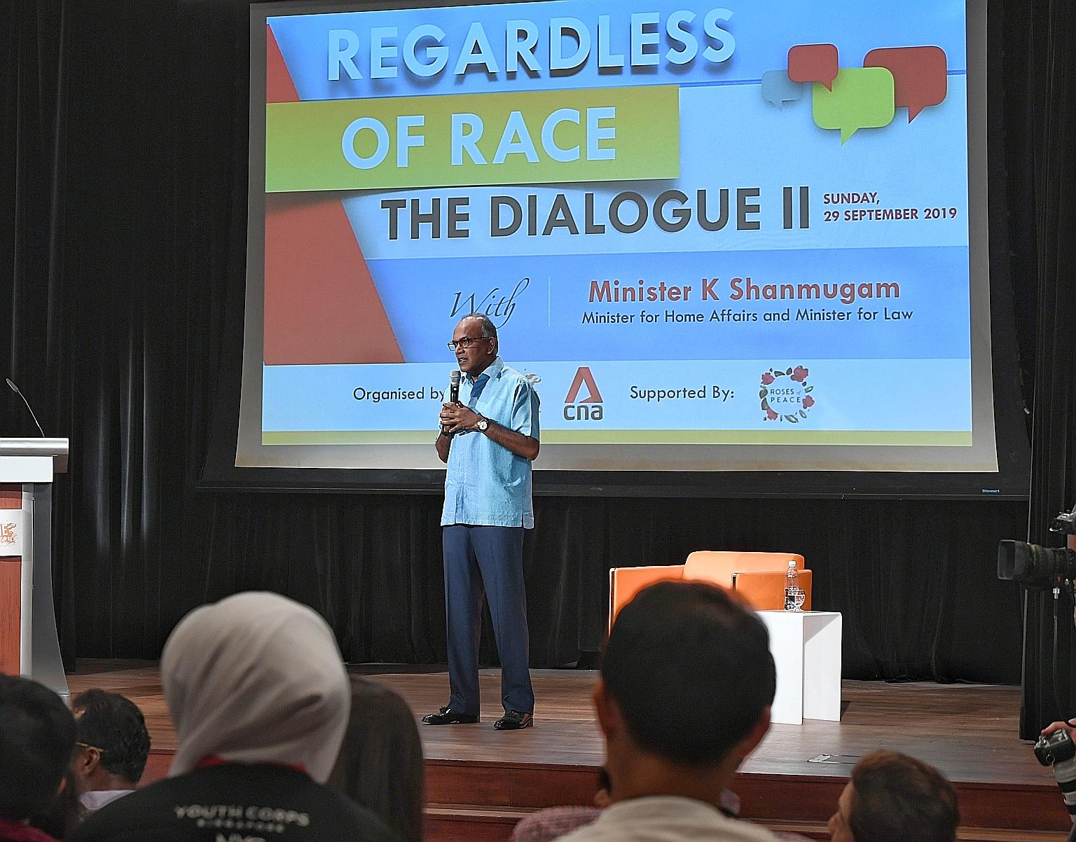 Home Affairs and Law Minister K. Shanmugam addressing the audience at yesterday's dialogue. He fielded questions on issues such as creating safe spaces for open discourse. ST PHOTO: KHALID BABA