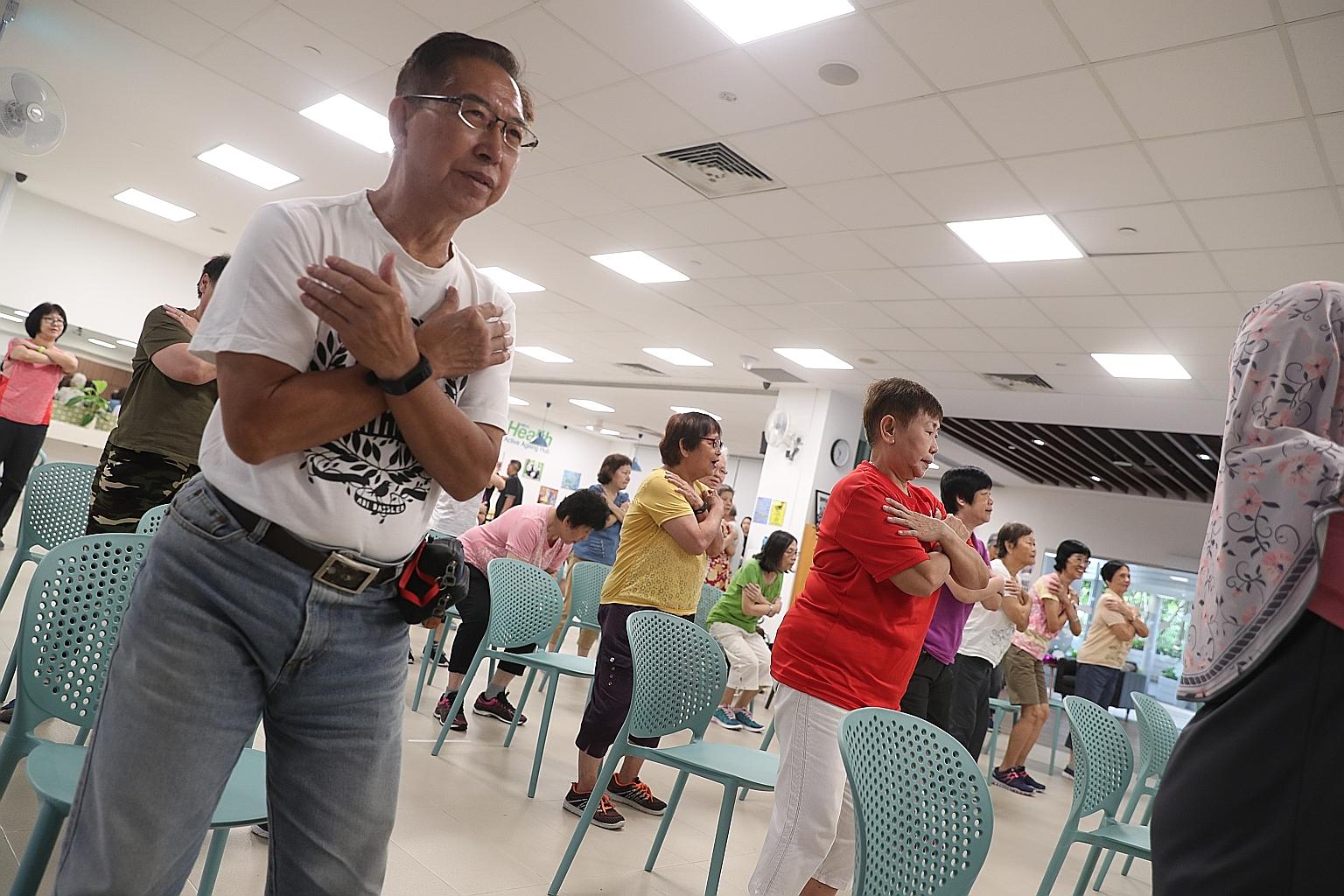 Mr Ho Soh Wah and Madam Mimi Wong (in red) taking part in a wellness programme at Kampung Admiralty's active ageing hub last week.
