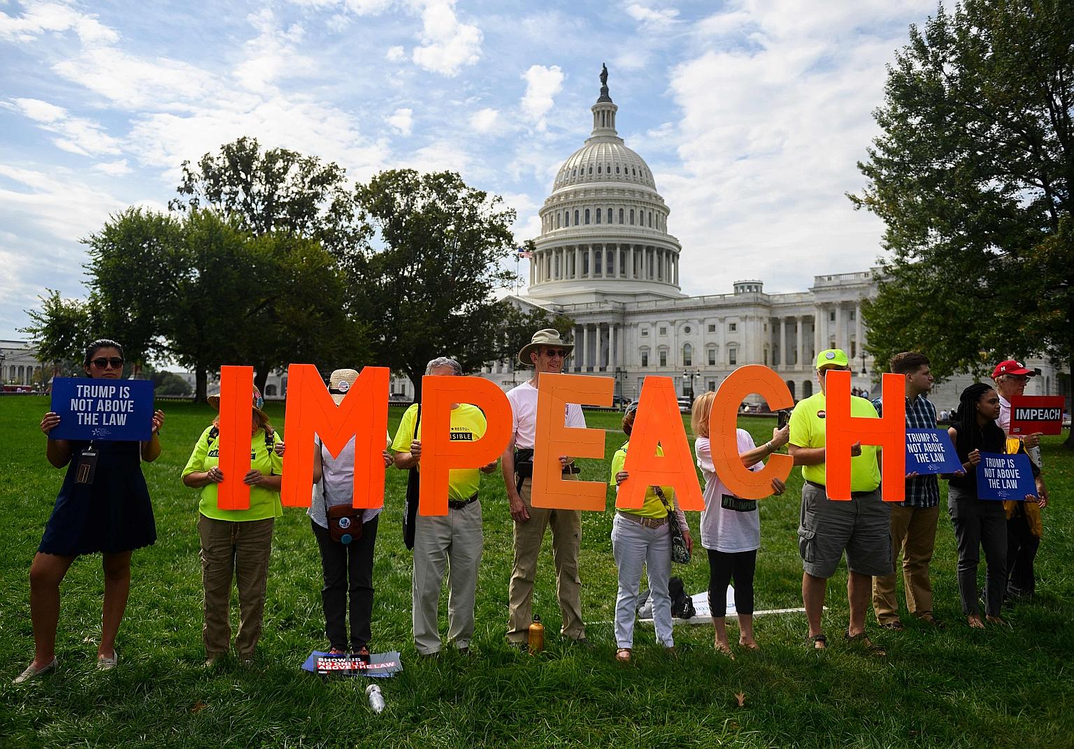 Protesters taking a stand against President Donald Trump in front of the US Capitol building during a "People's Rally for Impeachment" late last month. PHOTO: AGENCE FRANCE-PRESSE