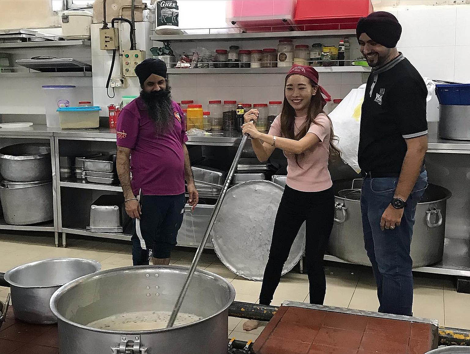 Social media influencer Sheena Phua with Young Sikh Association (YSA) president Sarabjeet Singh (at right) and a volunteer at the Central Sikh Temple. Law and Home Affairs Minister K. Shanmugam cited the association's reaching out to Ms Phua as an ex