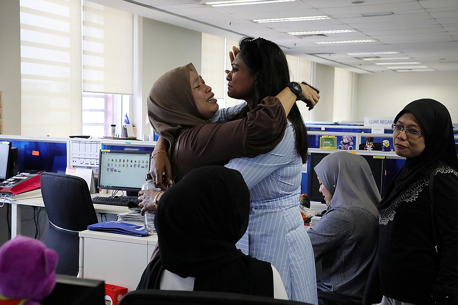 Employees of Utusan Malaysia in tears after the cash-strapped publisher went bust and laid off all staff yesterday. PHOTO: REUTERS