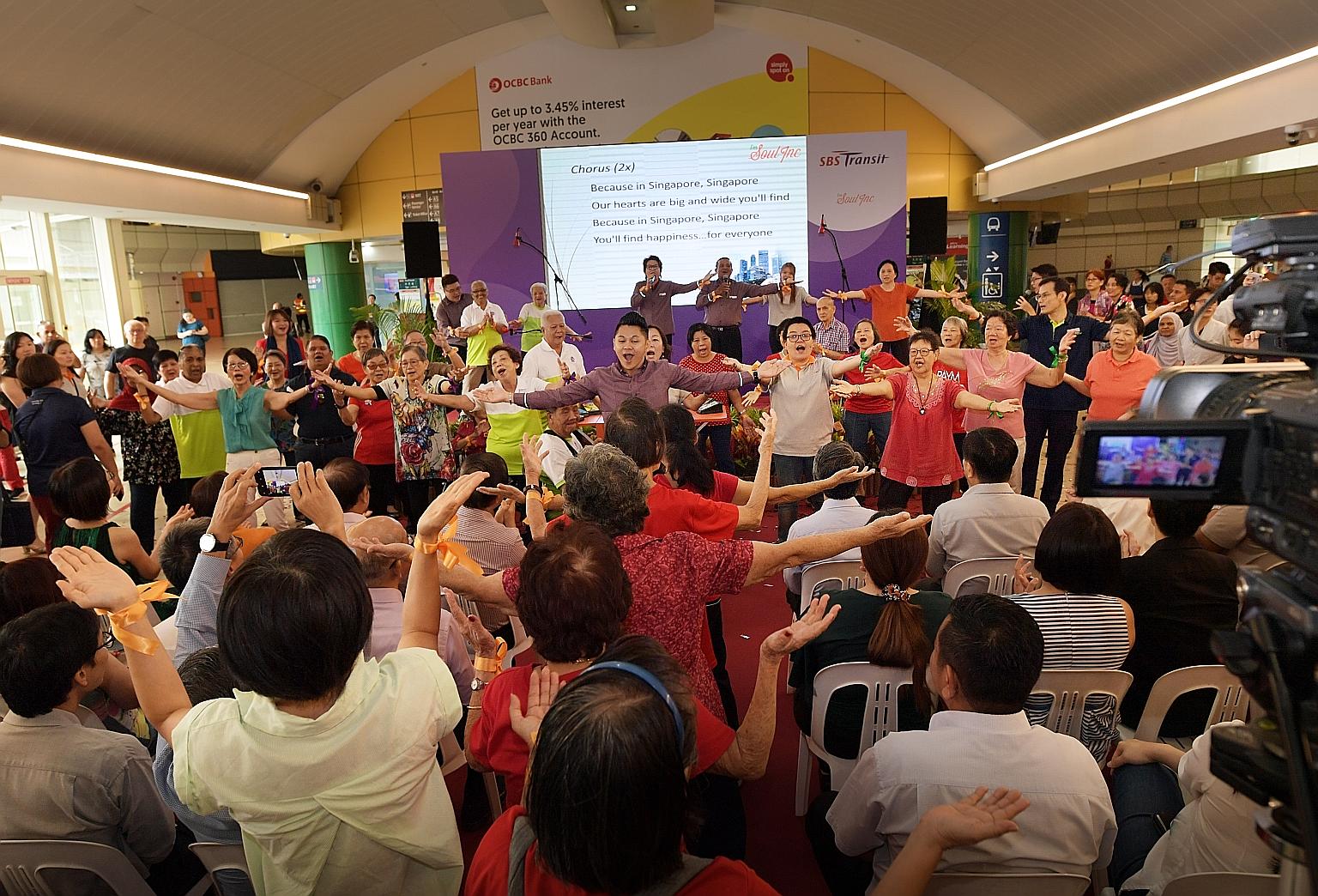 SBS Transit staff leading senior citizens in a dance session during the launch of The Magic Cares Van community programme. The programme, which aims to engage seniors and others with limited mobility, features touch-free music devices that use sensor