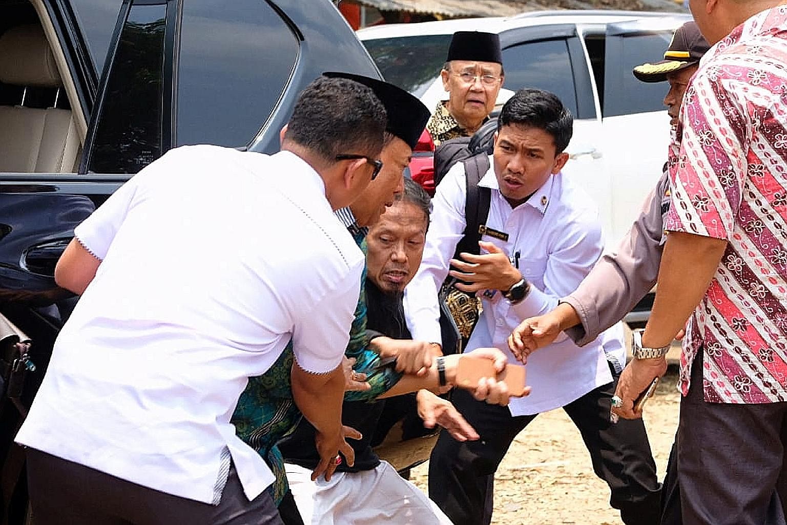 Indonesia's chief security minister Wiranto (in green) was yesterday stabbed in an attack by members of Jamaah Ansharut Daulah, the authorities said. The group is linked to the Islamic State in Iraq and Syria terror network. Mr Wiranto, the Coordinat