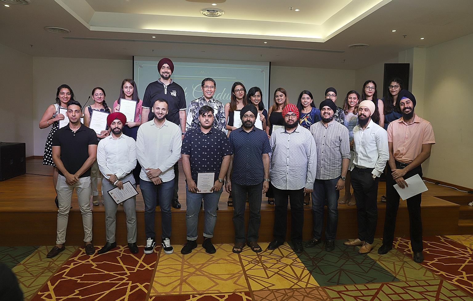Senior Minister of State for Defence and Foreign Affairs Maliki Osman (back row, centre) with Dr Ishwarpal Singh Grewal (front row, far right) and other young graduates at the annual Sikh Graduates Tea yesterday.