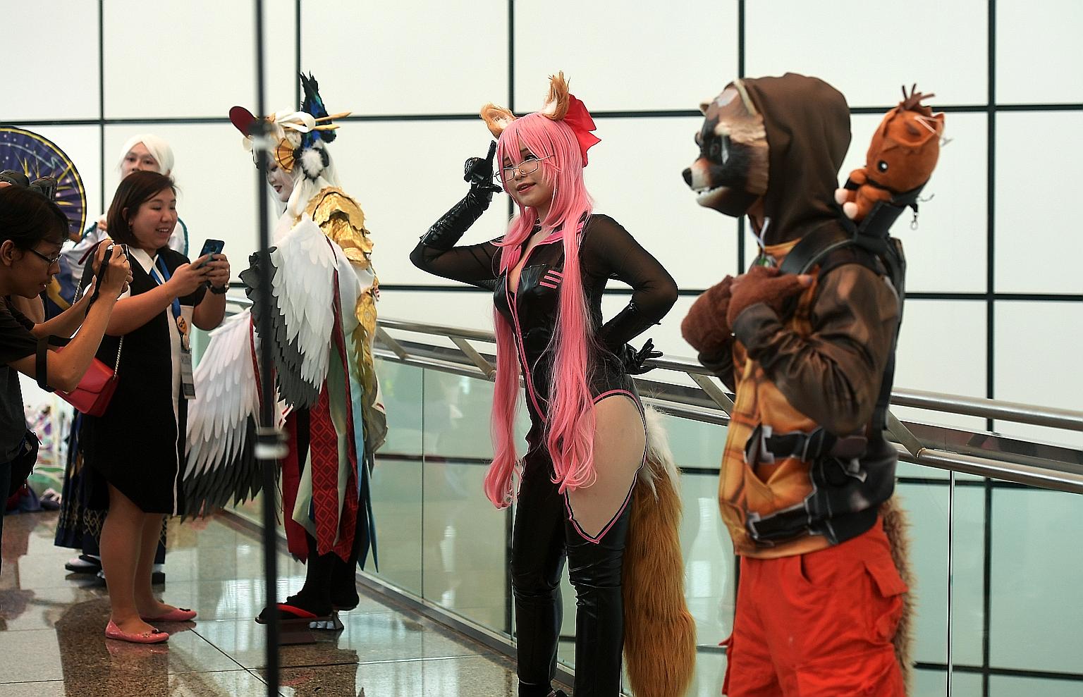 Vietnamese cosplayer Plant Lily (centre), dressed as the character Tamamo Vitch from the mobile game Fate/Grand Order, posing with other cosplayers or costume players at GameStart Asia 2019 at the Suntec convention centre last Saturday. The two other