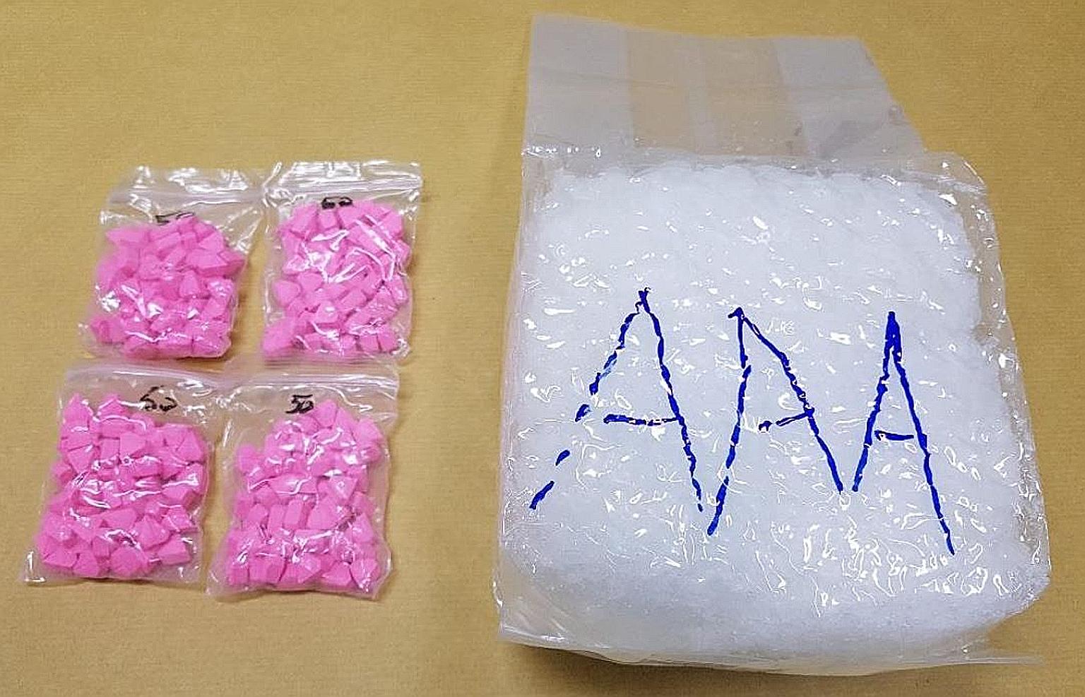 The authorities found 198 Ecstasy tablets and 1.041kg of Ice concealed in the air filter box in the bonnet of a car driven by a 34-year-old Malaysian man at Woodlands Checkpoint on Monday. PHOTO: CENTRAL NARCOTICS BUREAU