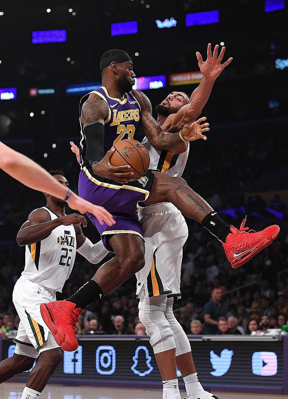 LeBron James making a pass around Rudy Gobert of the Utah Jazz during the Lakers' 95-86 win at the Staples Centre in Los Angeles. The Lakers all-rounder's presence at both ends of the court was instrumental to their first win of the new season.