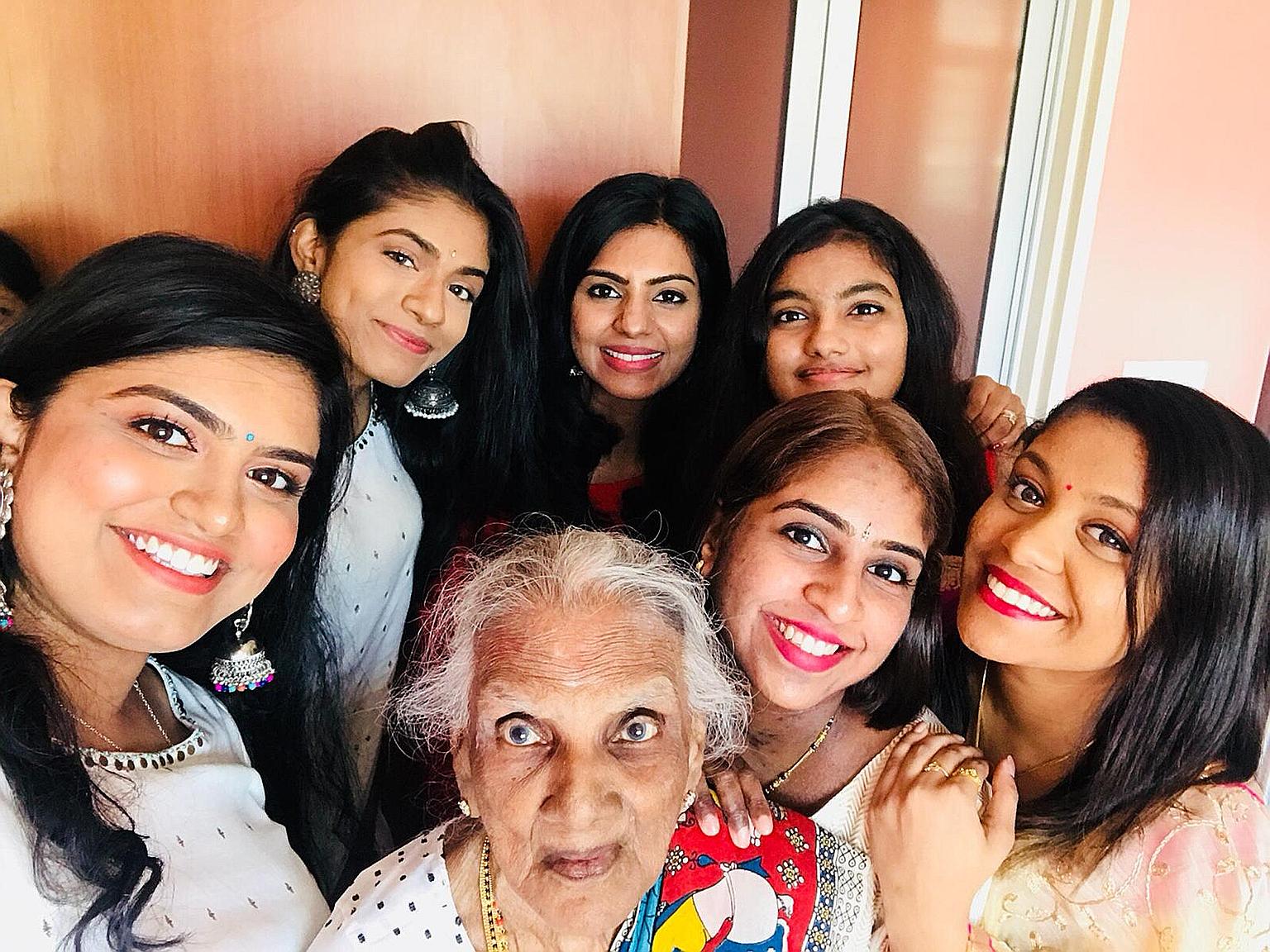 Madam Nadeson Pillai Muthulaxmy with her granddaughters (clockwise from left) Gangaa, Yamunaa, Radha, Tia, Divya and Karthiga at the Deepavali gathering at her flat in Henderson Road yesterday.