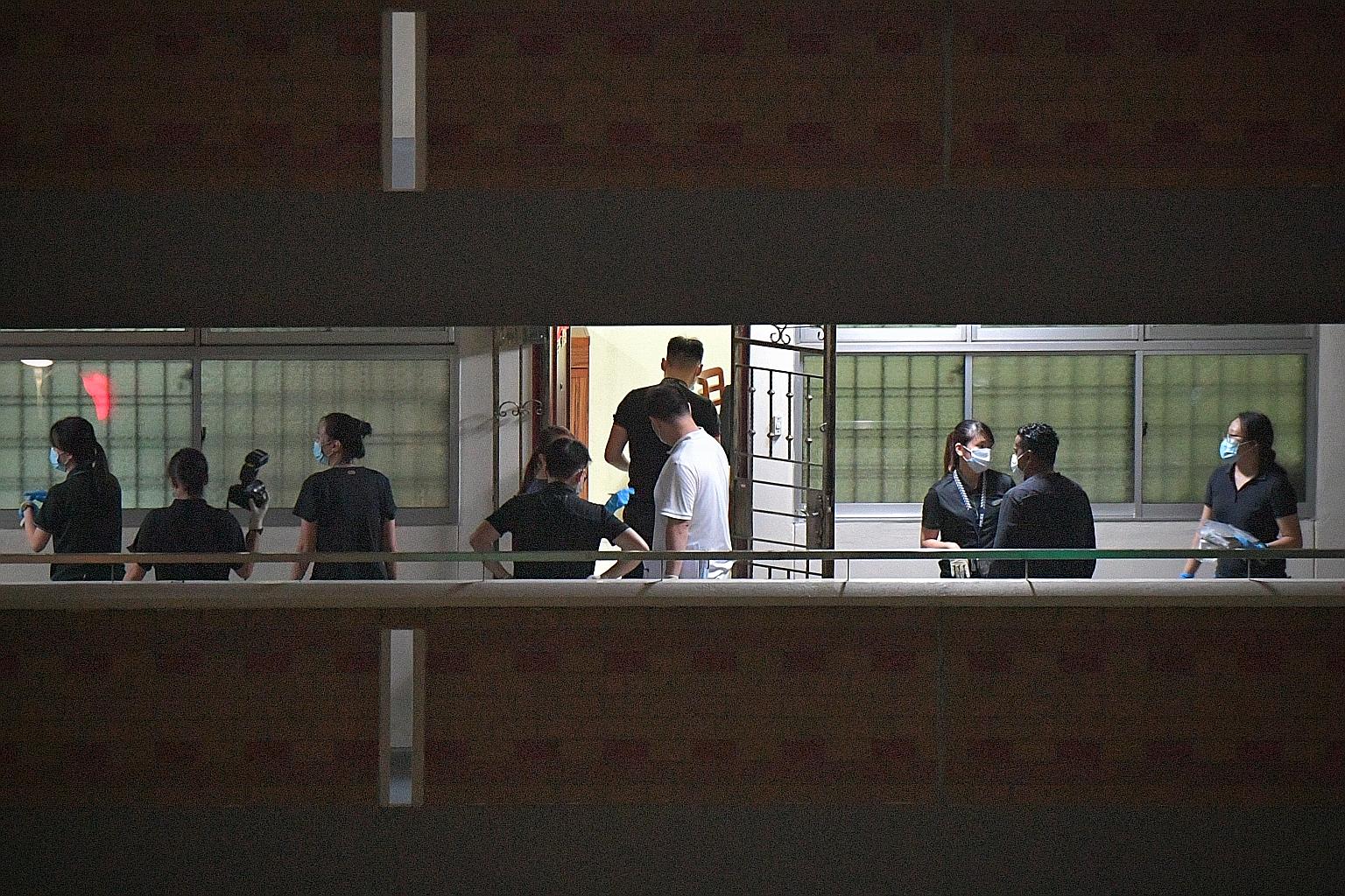 Police officers were seen gathering evidence at two adjacent units on the seventh floor of Block 7A in Commonwealth Avenue yesterday.ST PHOTO: ARIFFIN JAMAR