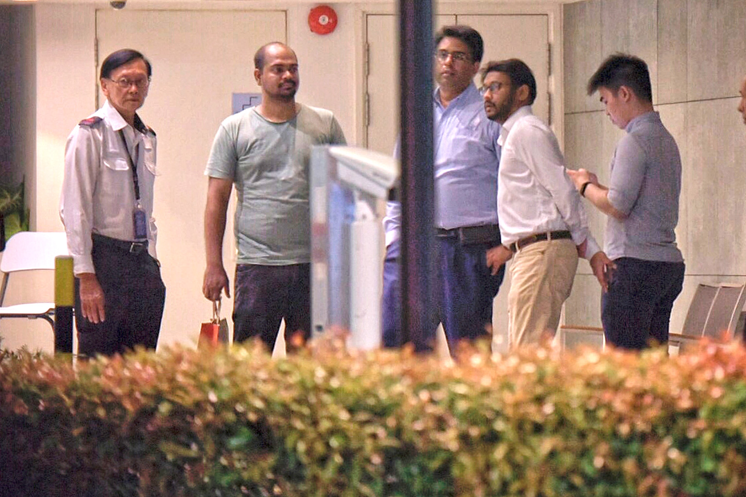 Senior security supervisor Steven Heng (left) with Association Of Certified Security Agencies honorary secretary Gary Haris (third from left) and Security Association of Singapore president Raj Joshua Thomas (fourth from left) before meeting the resi