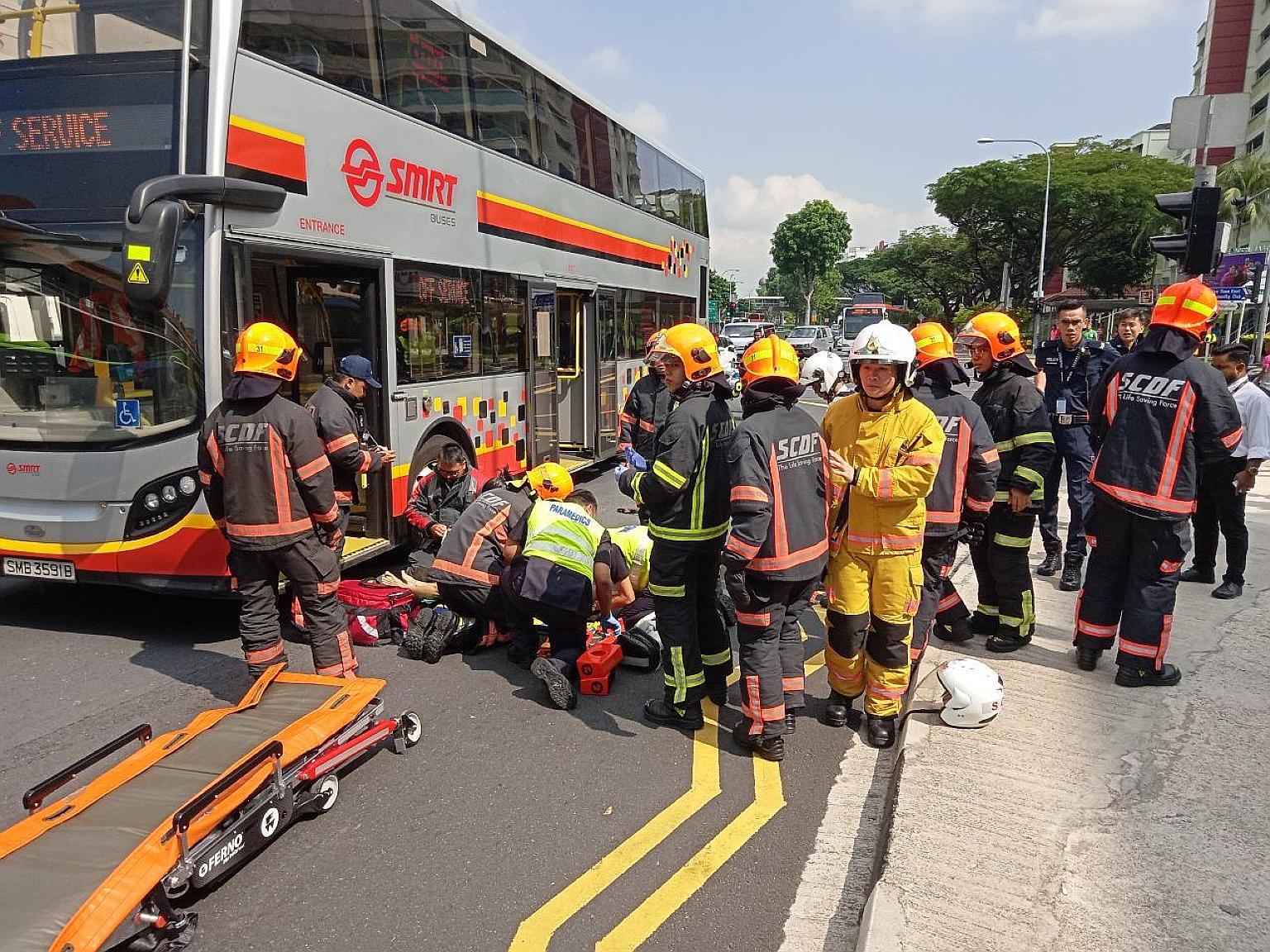 Rescue personnel seen attending to a 77-year-old pedestrian who was hit by an SMRT double-decker bus in Yishun on Tuesday, in this picture supplied by a witness who spoke to Lianhe Wanbao. The victim died in hospital from his injuries.