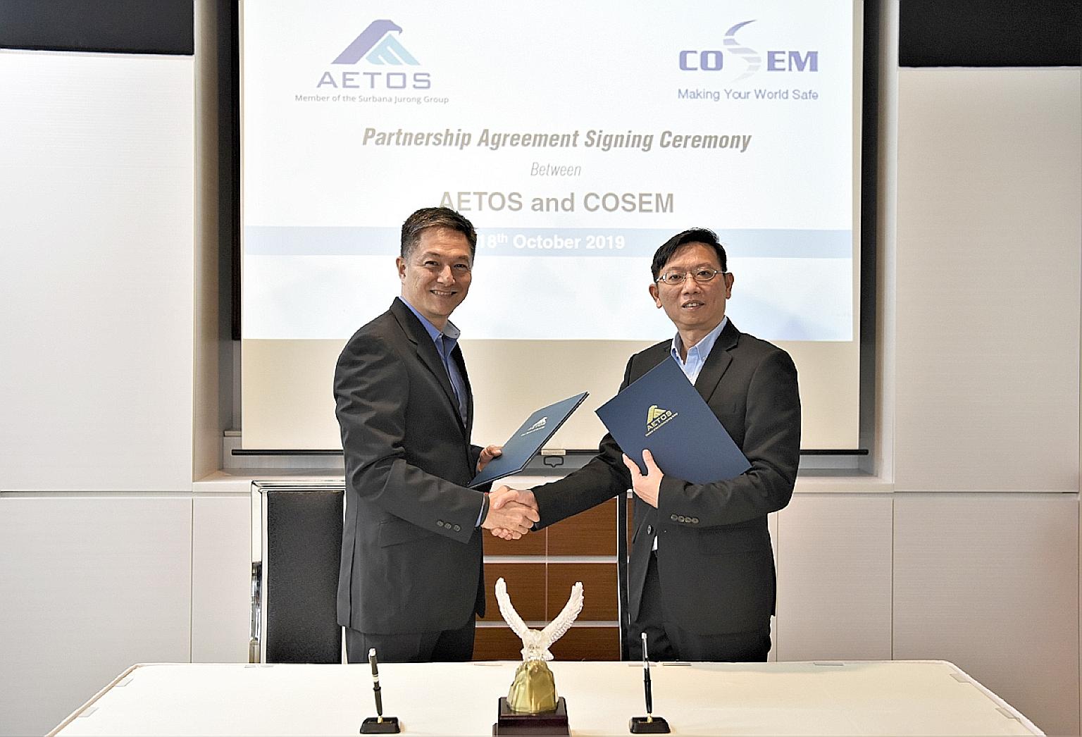 Aetos chief executive Alfred Fox (far left) and Cosem Safety & Security Services chief executive Ng Chee Kiang signed a memorandum of understanding last month. The tie-up between the two firms aims to tackle the manpower crunch in the safety and secu