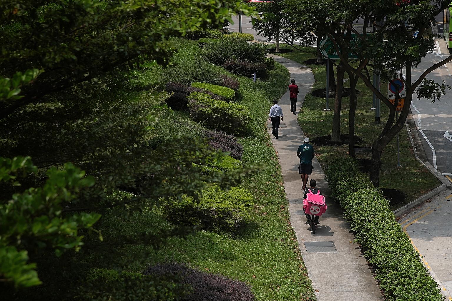 E-scooter riders on a footpath in Jurong East yesterday. There are about 7,000 food delivery riders in Singapore who use e-scooters, the majority believed to be working for Grab.