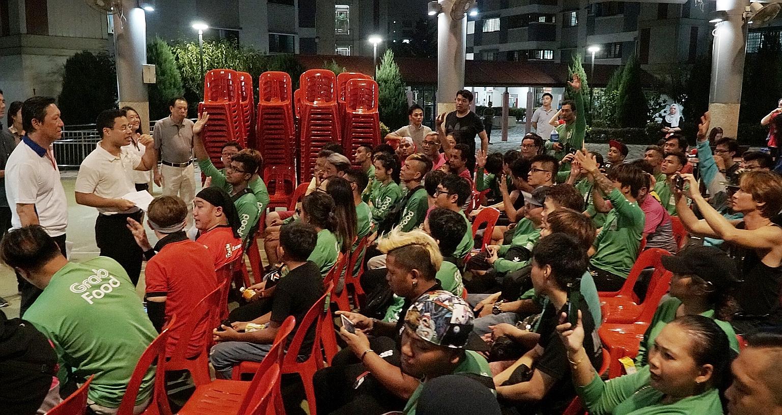 Minister for Social and Family Development Desmond Lee meeting a group of food delivery riders last night at his Meet-the-People Session in Jurong Spring. ST PHOTO: KHALID BABA