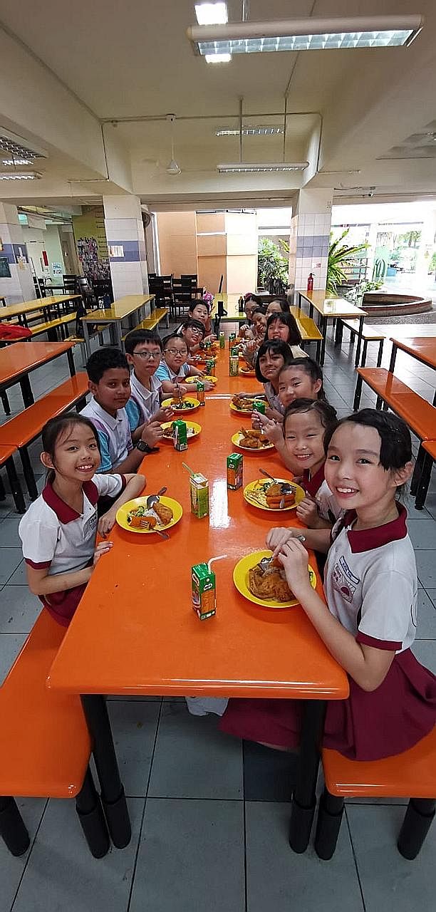 Pupils from Grace Orchard School and Rulang Primary School having lunch together before the start of their combined dance practice in July.