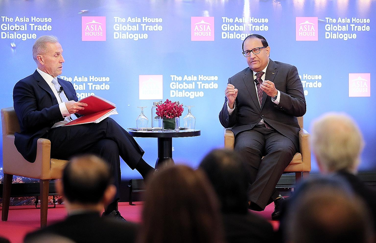 Minister-in-charge of Trade Relations S. Iswaran (right) said at yesterday's Asia House Global Trade Dialogue moderated by Asia House CEO Michael Lawrence that it is important to keep up the engagement with India. ST PHOTO: GAVIN FOO