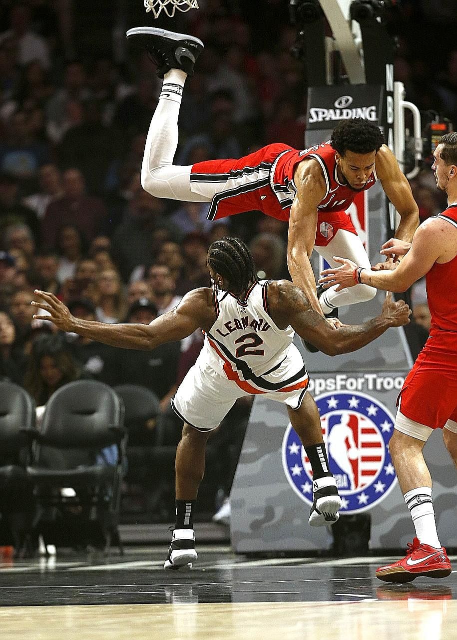 Portland Trail Blazers' Skal Labissiere impeding Kawhi Leonard of the Los Angeles Clippers illegally, during their game at the Staples Centre. Leonard recovered from being fouled to lead all scorers in an LA win. 