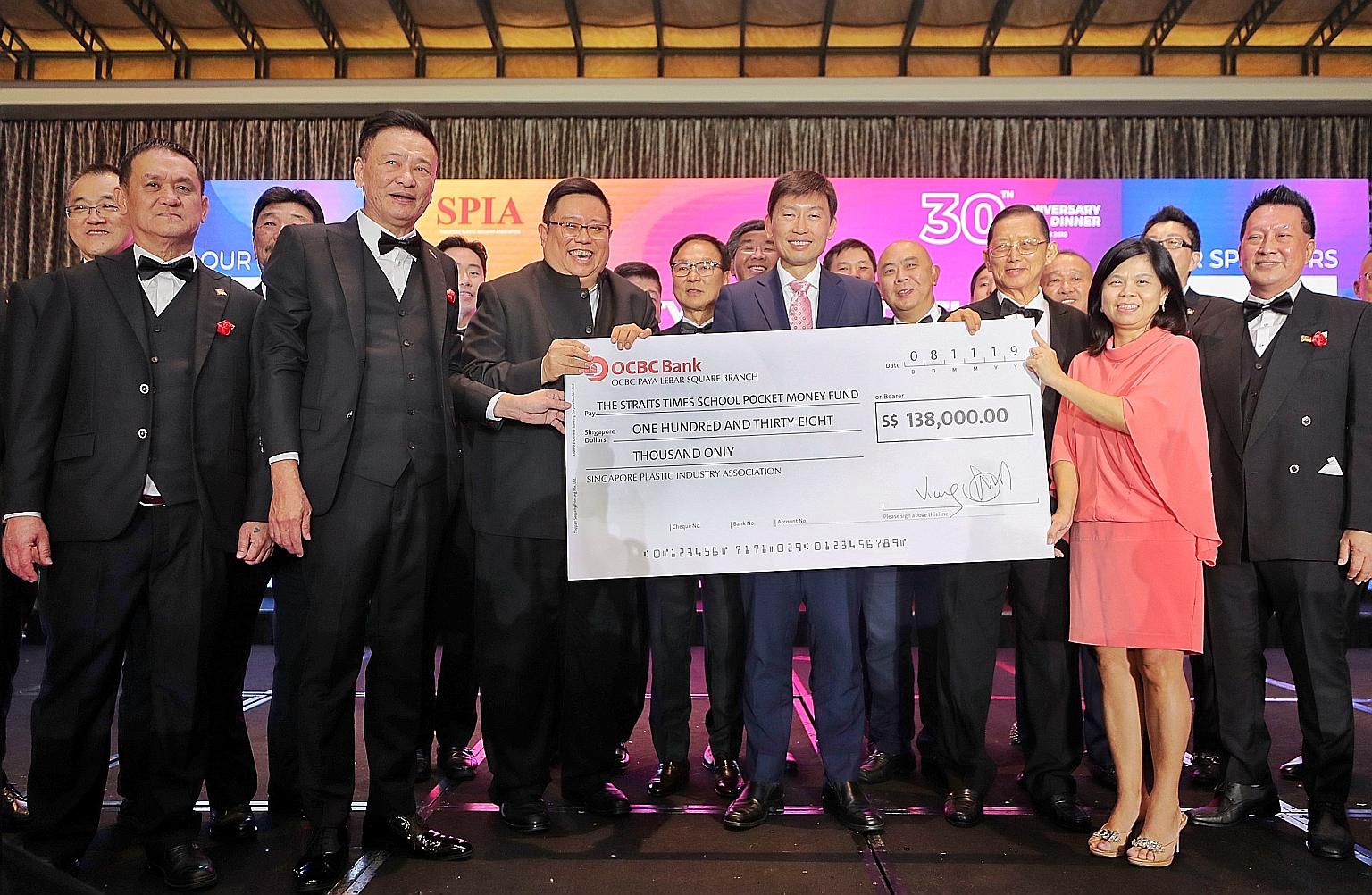 Senior Minister of State for Trade and Industry Chee Hong Tat (centre) at the 30th anniversary of the Singapore Plastic Industry Association, when SPIA donated $138,000 to The Straits Times School Pocket Money Fund (STSPMF). With Mr Chee are (from le