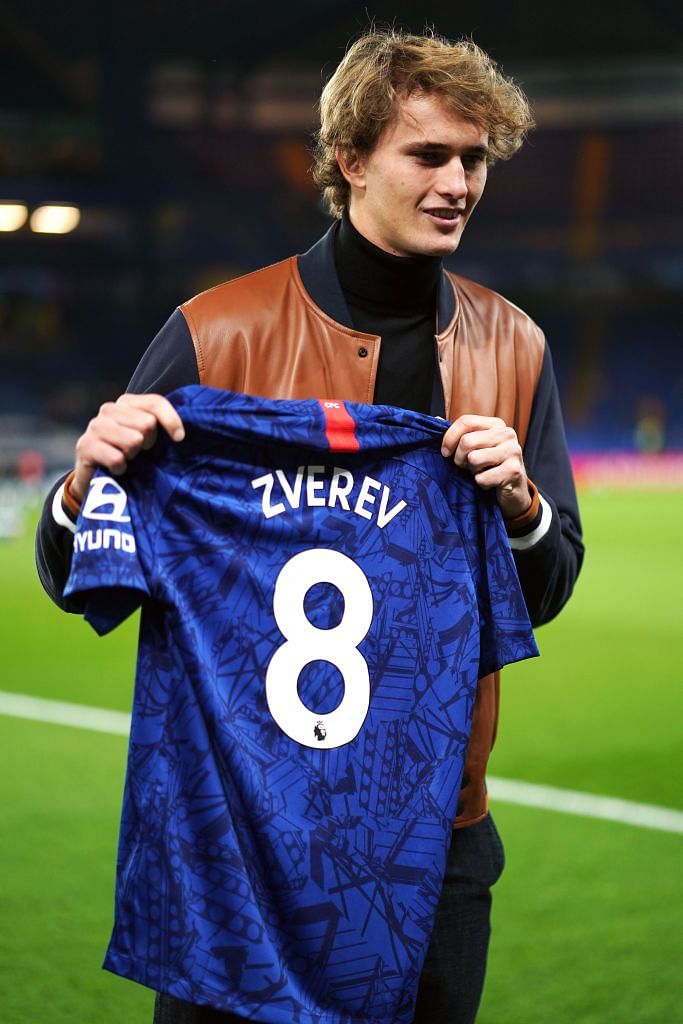 ATP Finals champion Alexander Zverev being presented with a Chelsea shirt before watching the 4-4 Champions League soccer thriller against Ajax at Stamford Bridge in London on Wednesday. He said on Instagram: “2 reds. 2 penalties. 2 disallowed goals. What