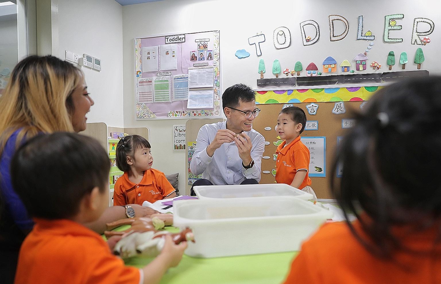Mr Chan Tee Seng, chief executive of NTUC First Campus, and English teacher Nurul Salhida interacting with toddlers at My First Skool in Jurong West last month. NTUC First Campus, which runs My First Skool, will be spending $3 million in the next thr