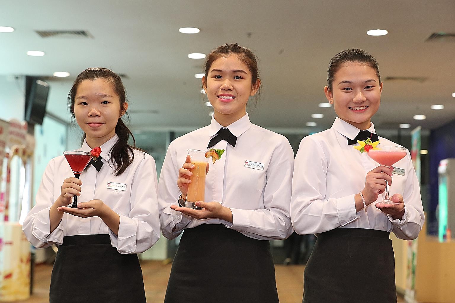From left: First runner-up Ting Chi Ying with her drink Merry Berry, winner Chow Ying Shun with Call Me Peachy and second runner-up Lee Yan Xuan Charlene with Pink Guavadise. The trio yesterday topped this year's The Greatest Mix - F&N Drinks Creatio