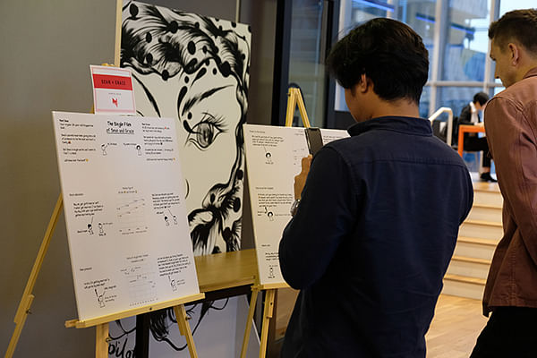 Attendees at the prize giving ceremony view the winning work by Goh Wei Ping and Jamie Soo, entitled “The single files of Sean & Grace” on Nov 14, 2019.