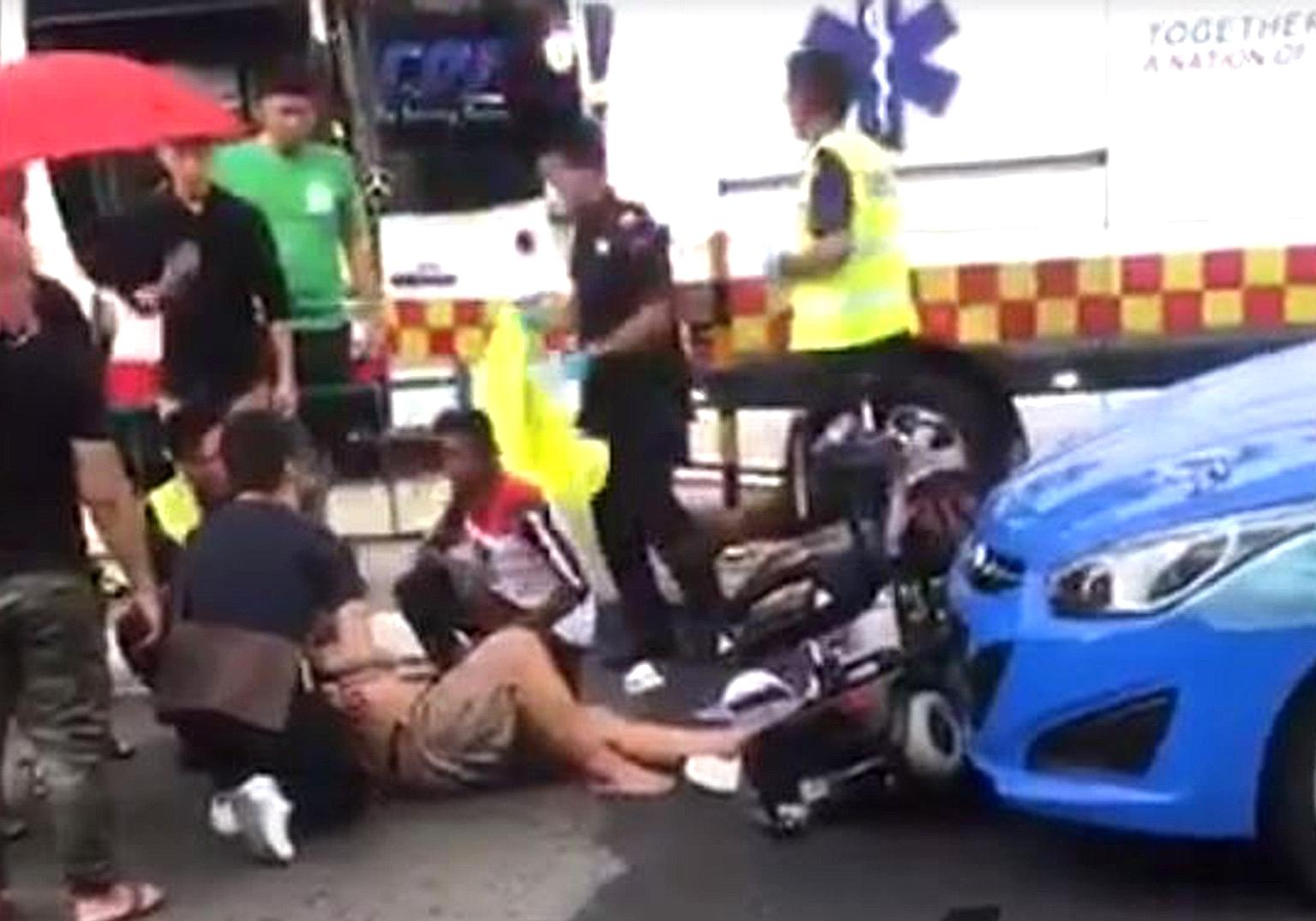 The rider of a personal mobility aid being tended to after a collision with a taxi in Choa Chu Kang last Saturday.