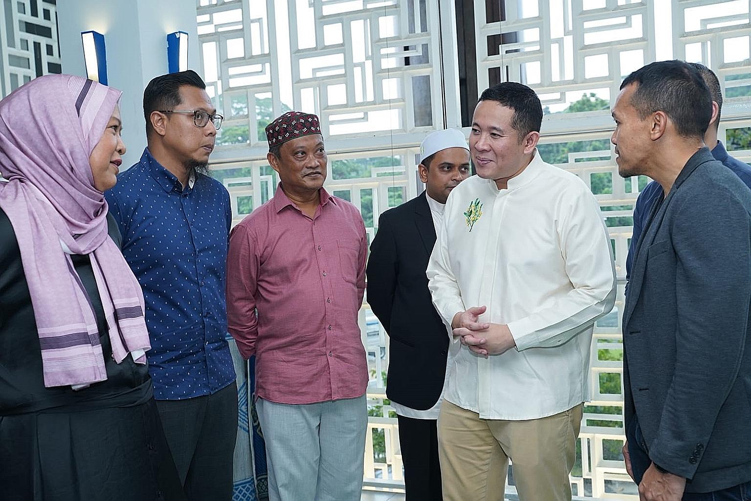 Senior Parliamentary Secretary for Home Affairs and Health Amrin Amin (in white) with community befrienders at a training session for Fitrah volunteers at Masjid Assyafaah in Sembawang last Saturday.