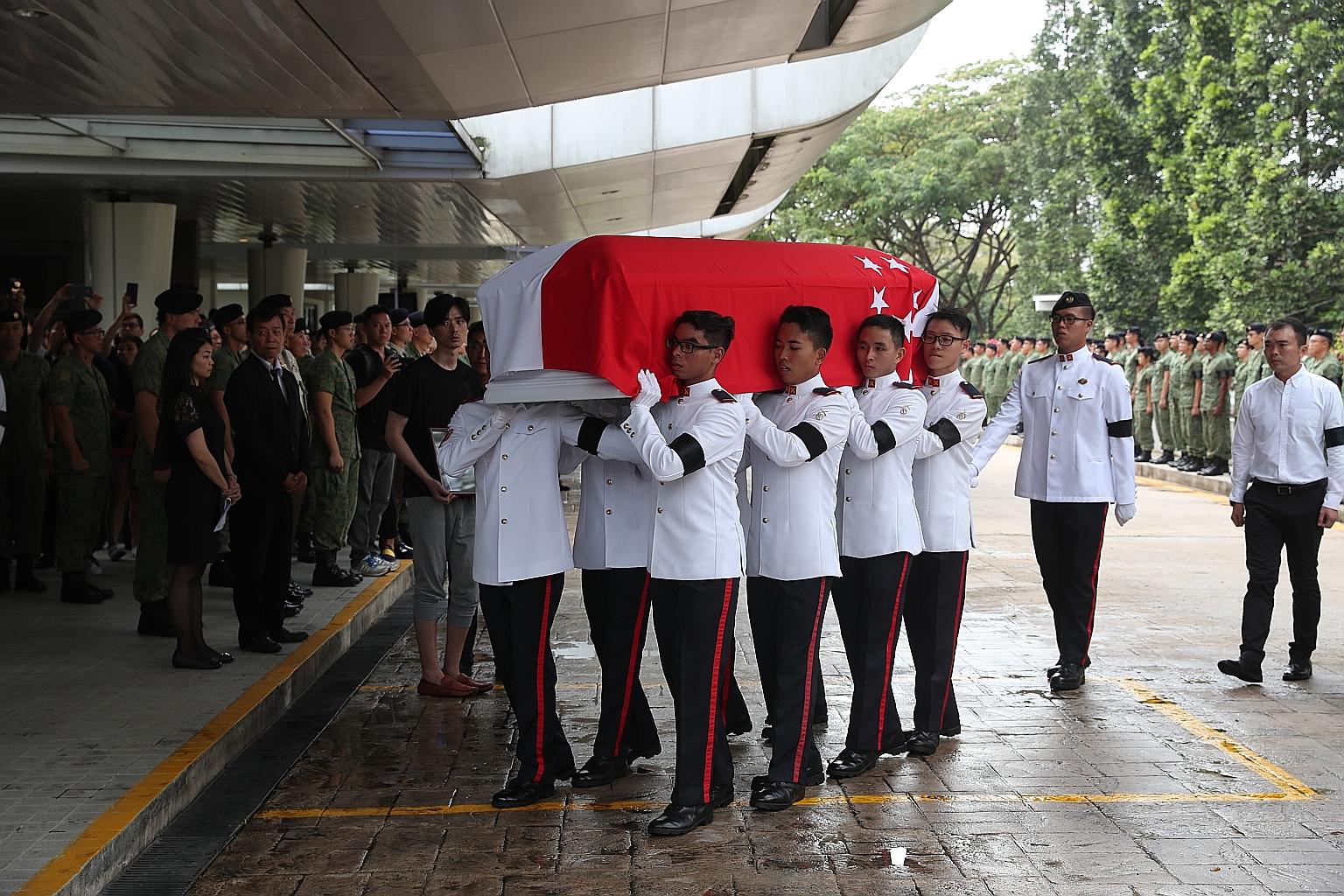 Singapore Armed Forces pall bearers carrying Corporal First Class (NS) Aloysius Pang's casket into Mandai Crematorium in January. CFC Pang died on Jan 23, four days after being seriously hurt during a live-firing exercise. ST FILE PHOTO