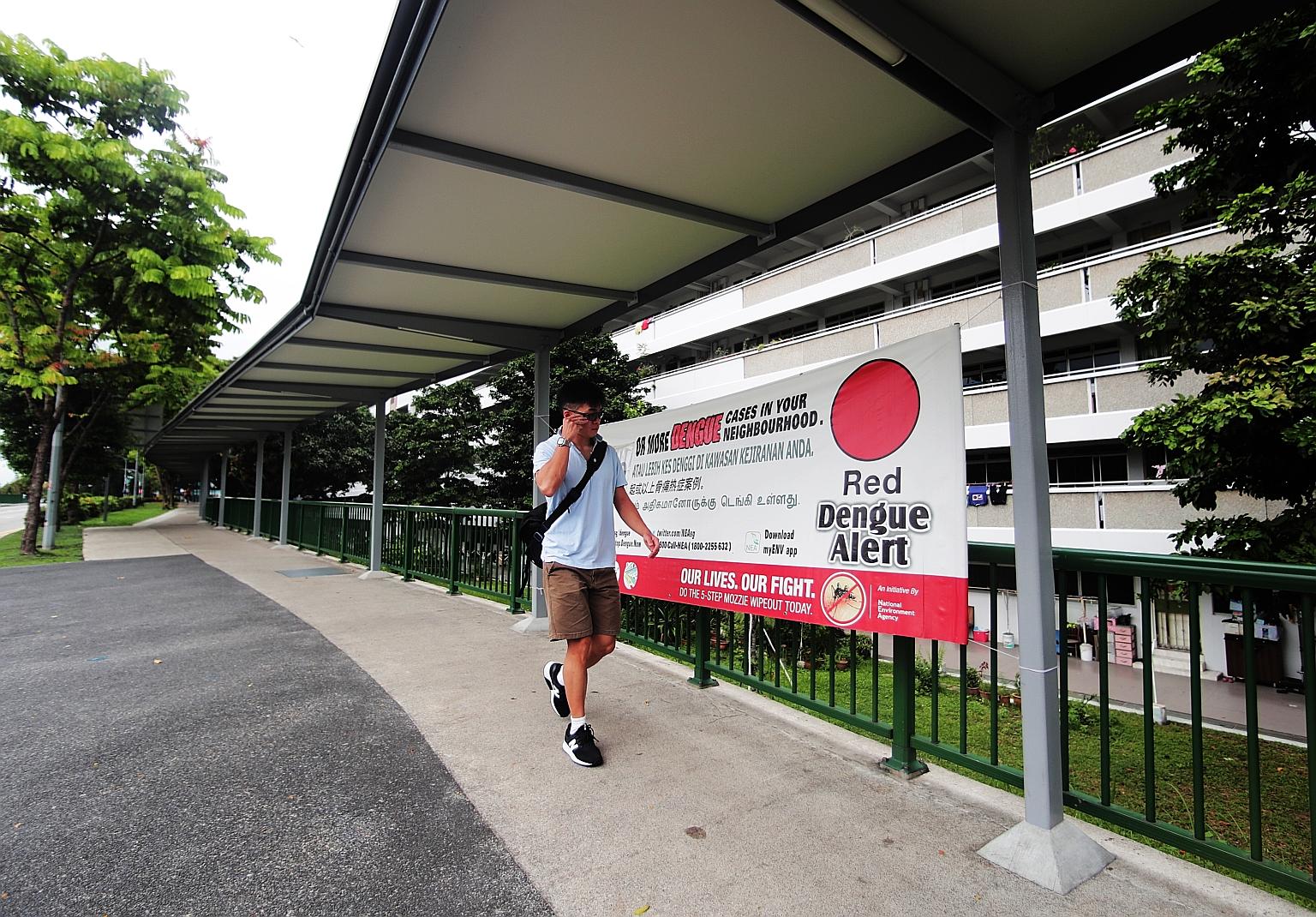 A Red Dengue Alert banner in Jurong West Street 61 yesterday. Last week was the fifth straight week of rising infections. The NEA said the Aedes population grew by 32 per cent last month over the previous month. ST PHOTO: KELVIN CHNG
