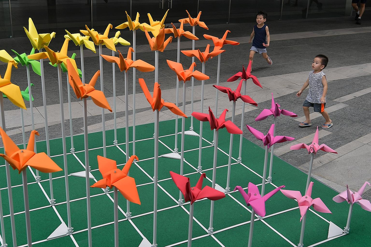 Children running to the ORIGAMe artwork by artist Tek Swee Lang installed at Guoco Tower in Tanjong Pagar for the Architectural Heritage Season.