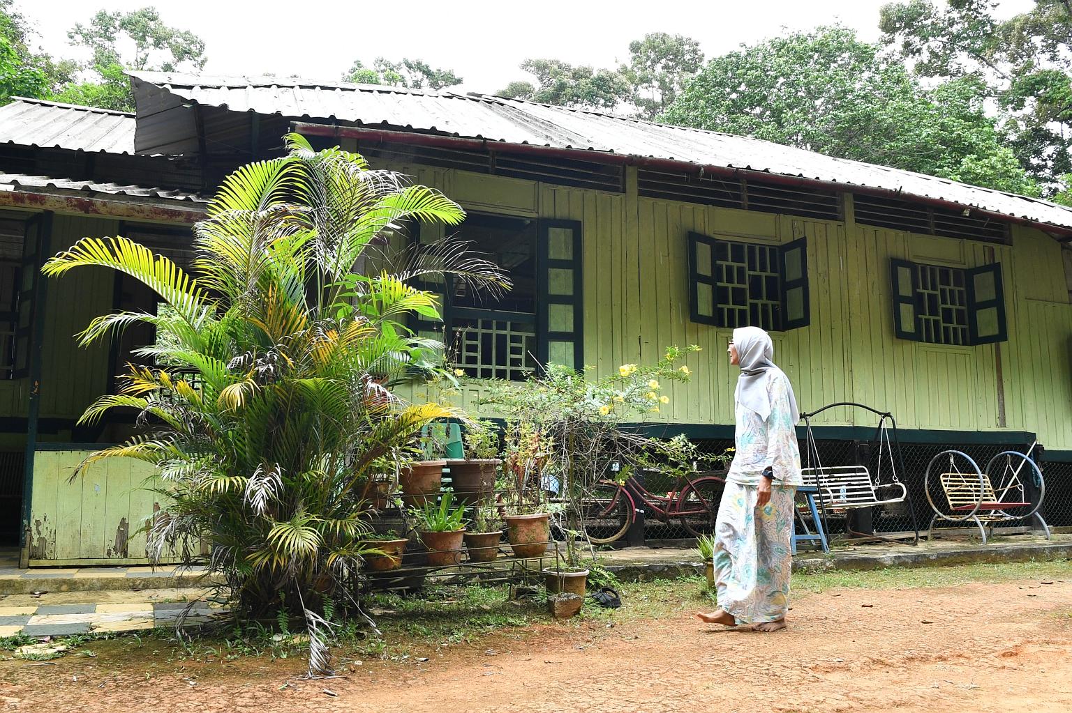 Madam Kamariah Abdullah outside her house on Pulau Ubin. She said she is grateful for the help she is getting to repair the ageing structure she grew up in, noting that it often takes a battering from strong winds and rain, as well as other forces of