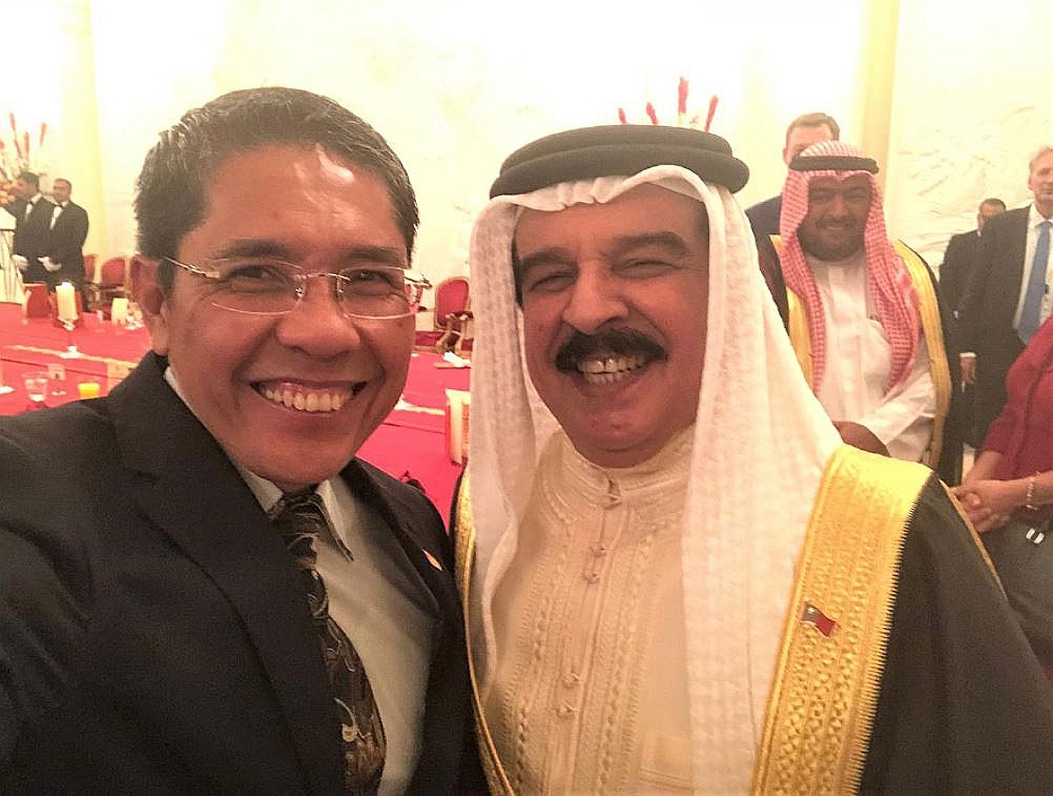 Senior Minister of State for Defence and Foreign Affairs Maliki Osman with Bahrain's King Hamad bin Isa Al Khalifa.
