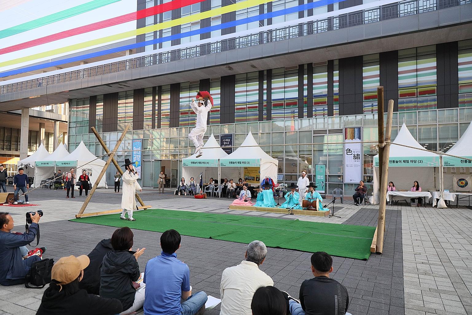 The traditional Korean art of tightrope walking, accompanied by music and witty dialogue between the tightrope walker and a "clown" on the ground, being performed in South Korea last month. PHOTO: NATIONAL INTANGIBLE HERITAGE CENTRE