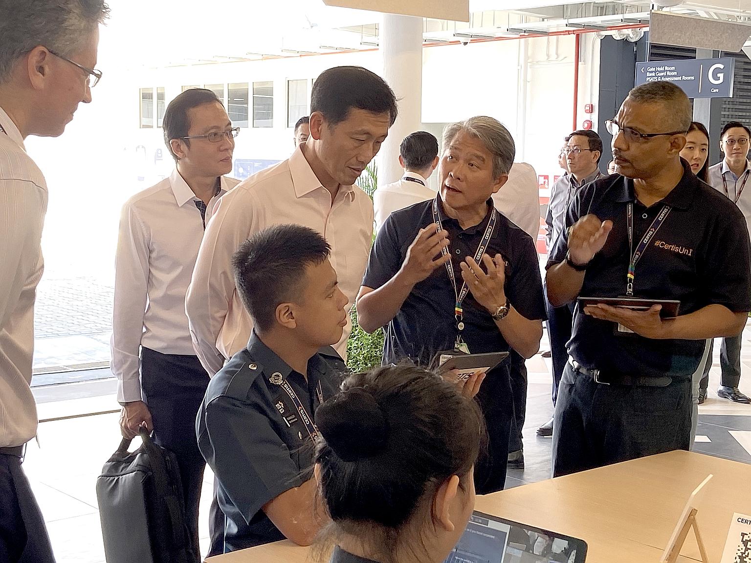 Trainers at Certis Corporate University explaining to Education Minister Ong Ye Kung, who officially launched the university yesterday, how online simulations of real-life situations can be used in timed assessments.