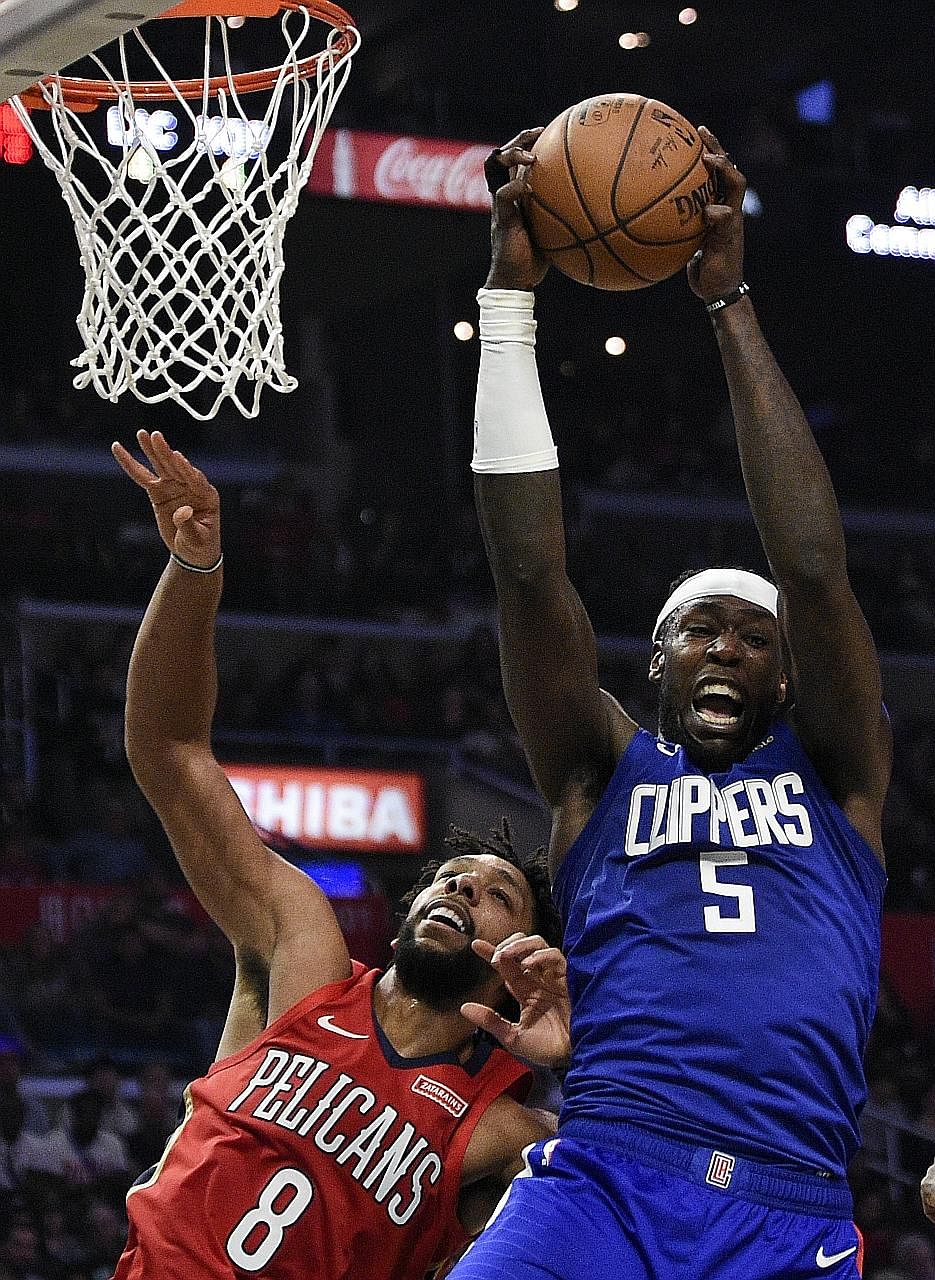 The Clippers' Montrezl Harrell beating the Pelicans' Jahlil Okafor to a rebound during the second half of their NBA regular-season game at the Staples Centre. The Clippers won 134-109, with guard Harrell getting a career-best 34 points. PHOTO: ASSOCI