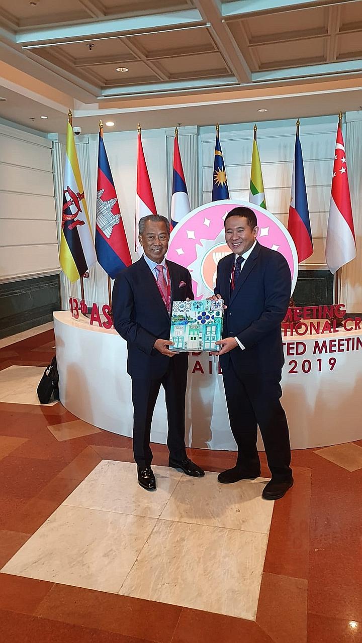 Senior Parliamentary Secretary for Health and Home Affairs Amrin Amin with Malaysia's Home Minister Muhyiddin Yassin (far left) during the 13th Asean Ministerial Meeting on Transnational Crime in Bangkok yesterday. PHOTO: MINISTRY OF HOME AFFAIRS