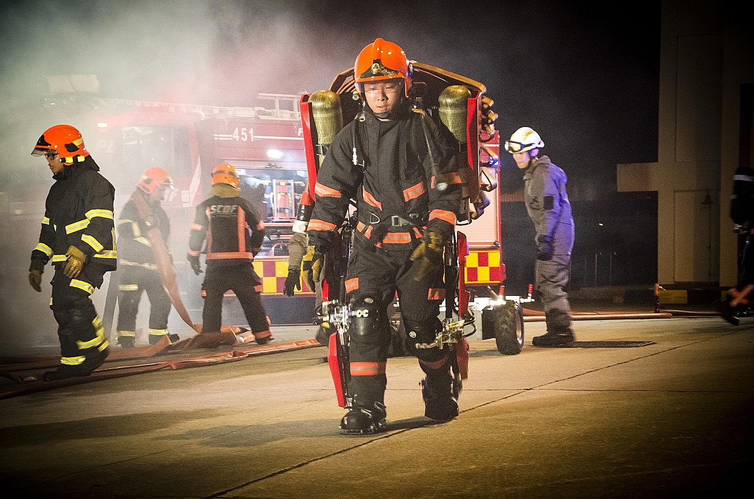 A member of the Singapore Civil Defence Force wearing an air-powered exoskeleton suit, believed to be the first of its kind in the world. It allows firefighters to carry heavy equipment of up to 40kg up multiple flights of stairs, and works in high h