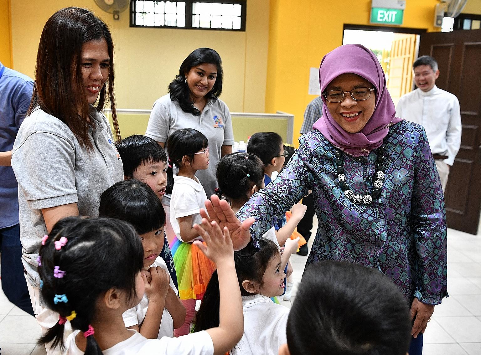 President Halimah Yacob interacting with children yesterday at the Gift of Love carnival in Pasir Ris, where she was the guest of honour. 