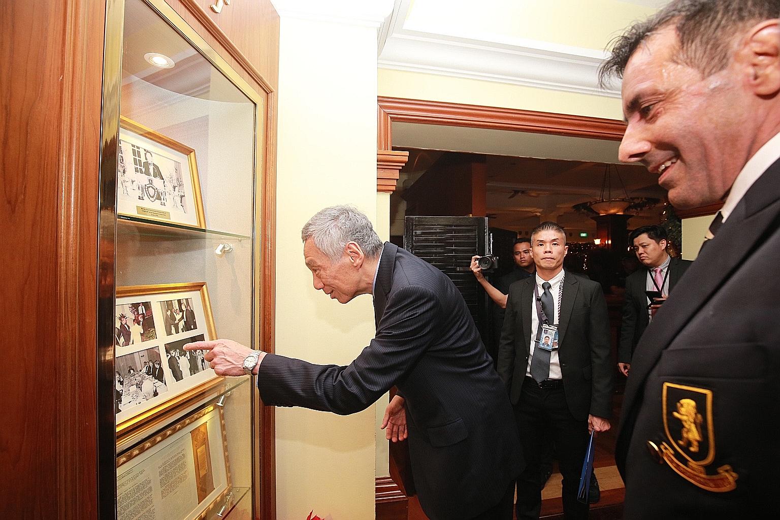 Prime Minister Lee Hsien Loong looking at photographs displayed at the Singapore Cricket Club which feature the late Mr Lee Kuan Yew. PM Lee was conferred the club's honorary title of Distinguished Visitor yesterday.