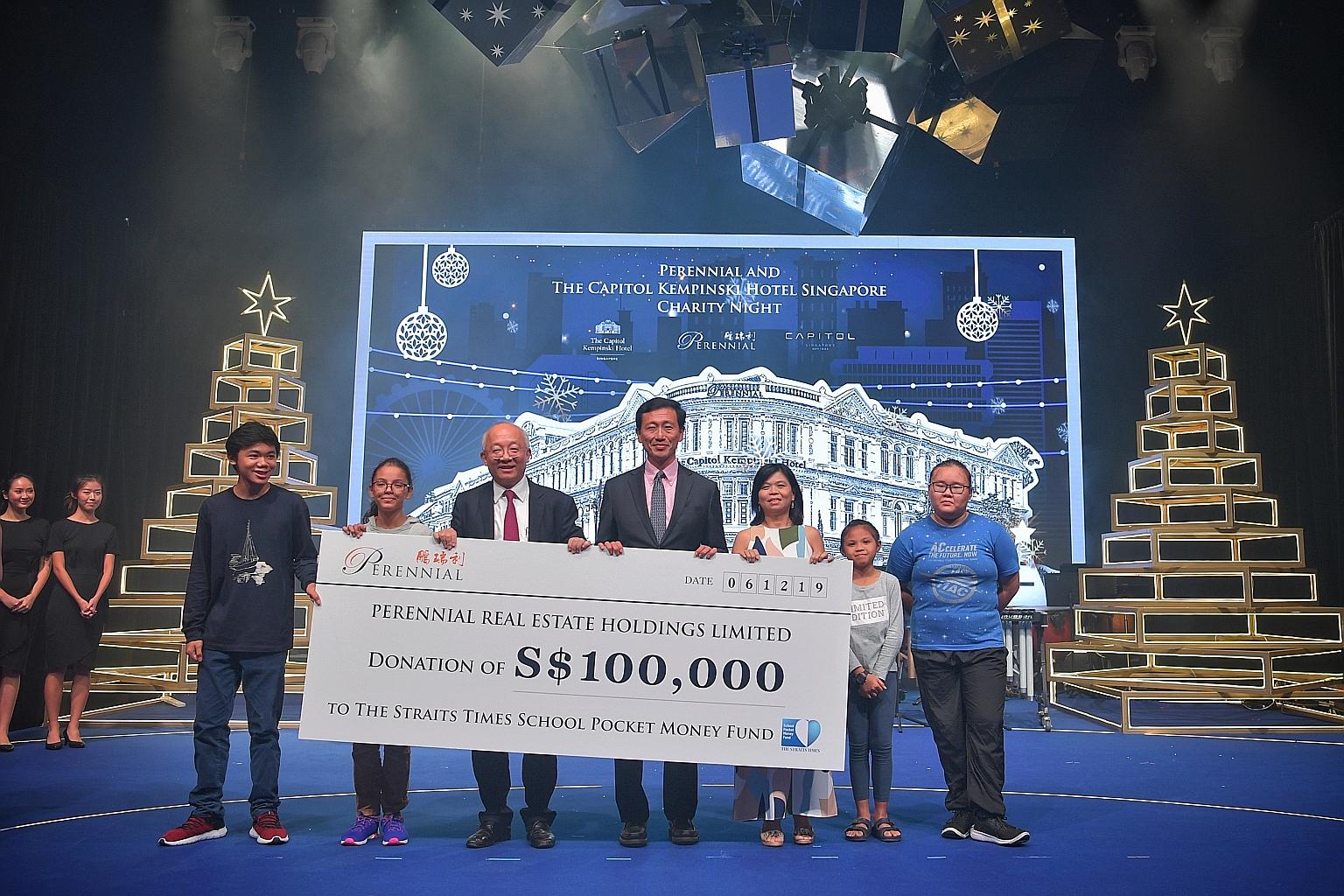 Education Minister Ong Ye Kung flanked by Mr Pua Seck Guan, director and chief executive of Perennial Real Estate Holdings, and Ms Tan Bee Heong, general manager of The Straits Times School Pocket Money Fund, with beneficiaries of the fund at Capitol