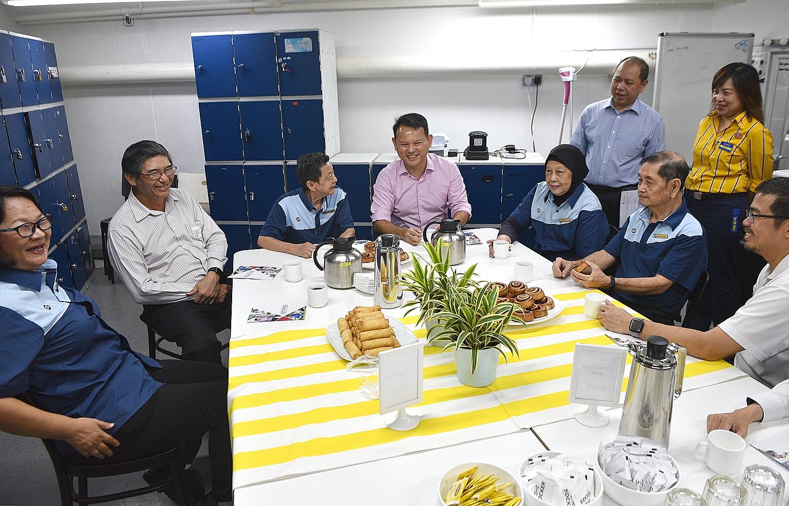Minister of State for Manpower Zaqy Mohamad (centre), Singapore National Employers Federation member Jeffrey Chua (second from left) and National Trades Union Congress assistant secretary-general Zainal Sapari (right) with cleaners (from left) Lew Ch